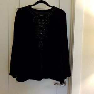 Velvet top with jewel neckline.